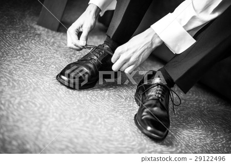 Groom dressing his boots 29122496