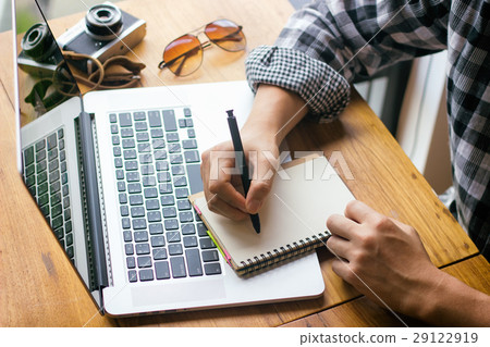 businessman writing a notebook on a wooden desk 29122919