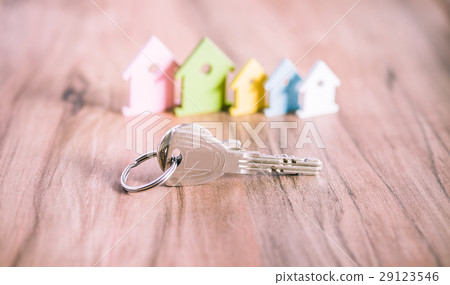 Silver Keychain laying on wooden Surface in front Silver Keychain laying on wooden Surface in front 29123546