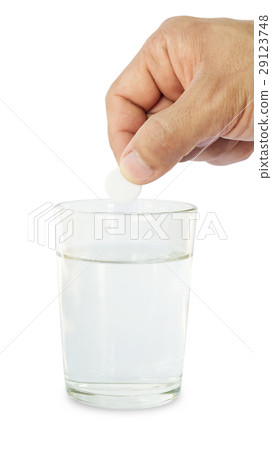 Man holding medicine on a glass of water. Man holding medicine on a glass of water. 29123748
