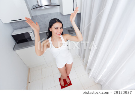 Happy woman weighing in morning and gesturing rise Happy woman weighing in morning and gesturing rise 29123987