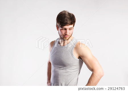 Handsome fitness man in gray tank top shirt Handsome fitness man in gray tank top shirt 29124763