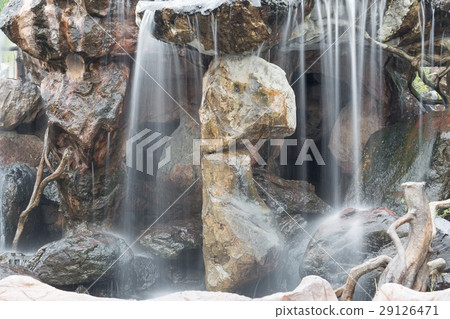 Waterfall flowing over rocks in the garden 29126471