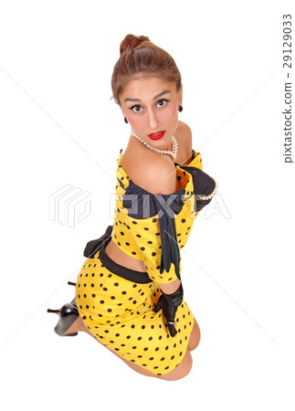 Lovely woman kneeling in yellow dress. Lovely woman kneeling in yellow dress. 29129033