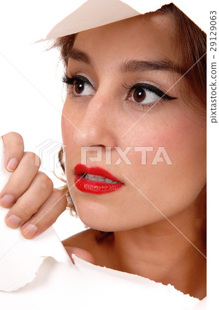 Pretty woman looking through hole. Pretty woman looking through hole. 29129063