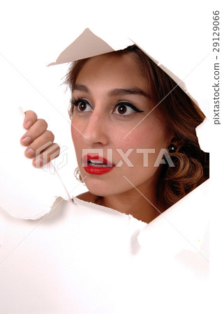 Pretty woman looking through a hole. Pretty woman looking through a hole. 29129066