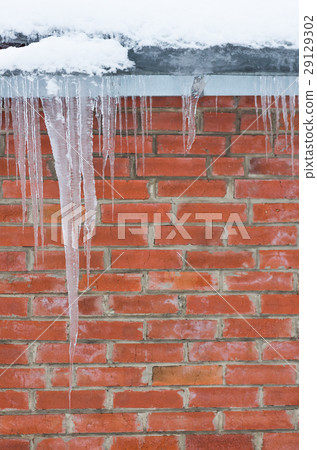 icicles on a background of red brick wall icicles on a background of red brick wall 29129302