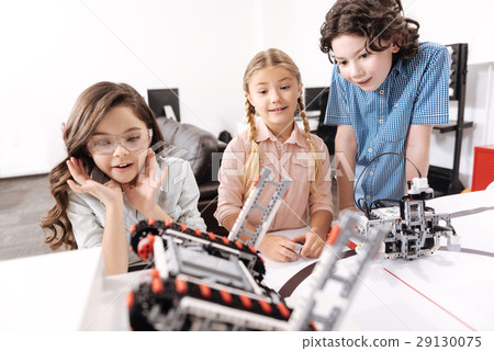 Shocked kids observing electronic robots at school Shocked kids observing electronic robots at school 29130075
