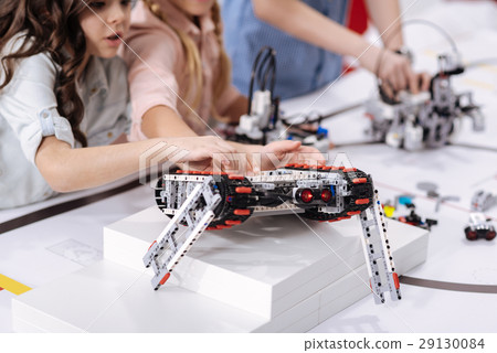 Involved schoolchildren observing electronic 29130084