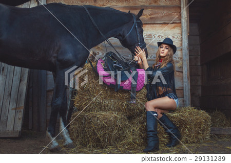 Woman cowboy with a horse. 29131289