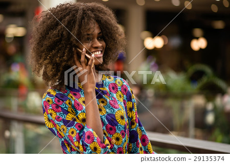 Afro-american woman talking on the phona and 29135374