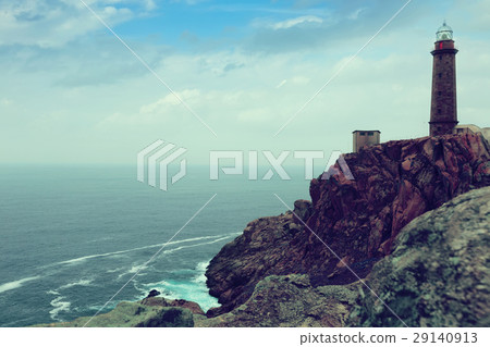 Toned photo with the lighthouse on the rocky coast Toned photo with the lighthouse on the rocky coast 29140913