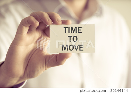 Businessman holding TIME TO MOVE message card Businessman holding TIME TO MOVE message card 29144144