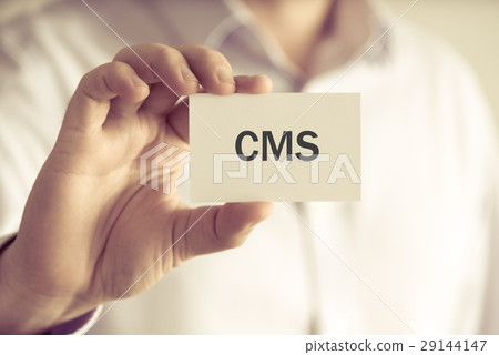 Businessman holding CMS message card 29144147