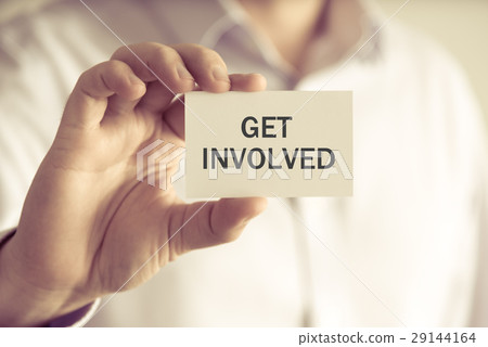 Businessman holding GET INVOLVED message card 29144164