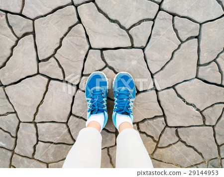 Top view of blue shoes on cracked floor 29144953