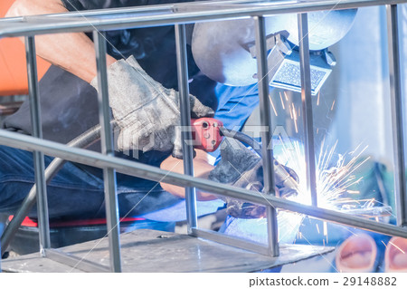 Making sure he's protected while welding Making sure he's protected while welding 29148882