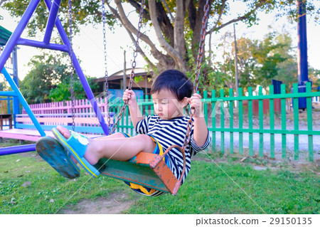 Young Asian boy play a iron swinging at playground 29150135