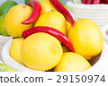 lemons and chili peppers in a wicker baske 29150974