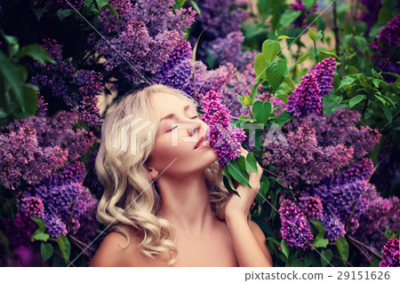 Beautiful Woman Enjoying the Smell of Lilac 29151626
