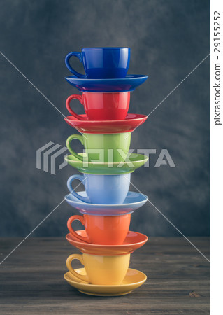 Stack of six multicolored cups on table 29155252