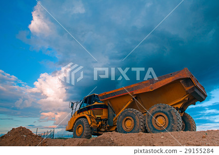 Yellow truck at work site before storm 29155284