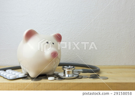 piggy bank with stethoscope and coins piggy bank with stethoscope and coins 29158058