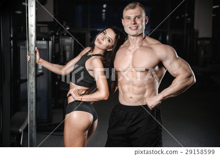 sexy caucasian man and woman in gym . sexy caucasian man and woman in gym . 29158599
