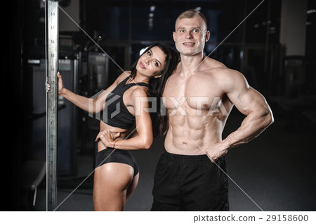 sexy caucasian man and woman in gym . sexy caucasian man and woman in gym . 29158600