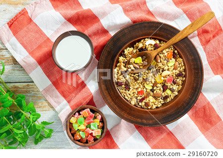 granola  in clay plate on kitchen towel 29160720