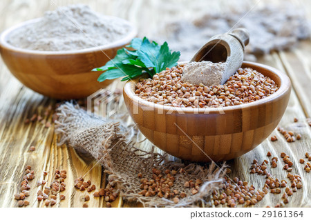 Wooden bowls with buckwheat and flour. 29161364