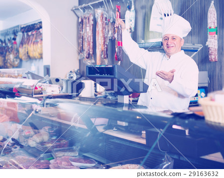 butcher with wurst at counter 29163632
