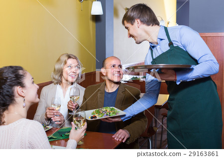 Waiter serving table in restaurant . Waiter serving table in restaurant . 29163861