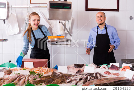 Two sellers in fish store . Two sellers in fish store . 29164133