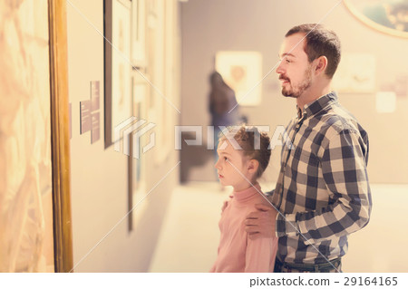 Glad man and girl exploring exhibition of photos Glad man and girl exploring exhibition of photos 29164165