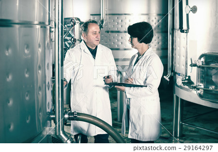 Elderly wine maker shows to expert equipment 29164297