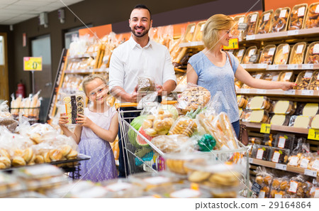 Family buying bread in food store. 29164864