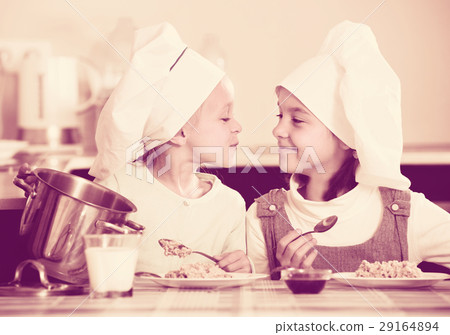 girls having breakfast with porridge girls having breakfast with porridge 29164894