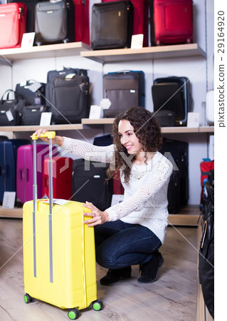 Woman selecting handy trunk in store. 29164920