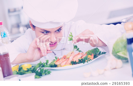 Young smiling chef with fried shrimps indoors Young smiling chef with fried shrimps indoors 29165393