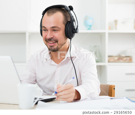 Positive man in headphones near computer 29165650