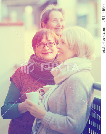 Senior women drinking tea at balcony Senior women drinking tea at balcony 29165696