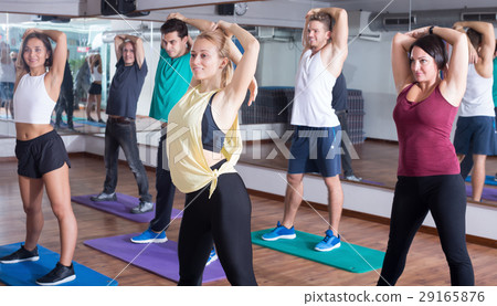 Happy people studying zumba elements in dancing class Happy people studying zumba elements in dancing class 29165876