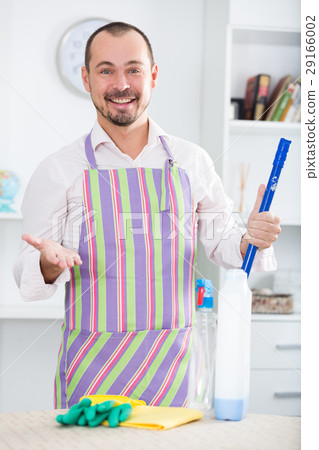 Young man in apron cleaning table 29166002