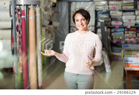 Brunette woman in textile shop. Brunette woman in textile shop. 29166124