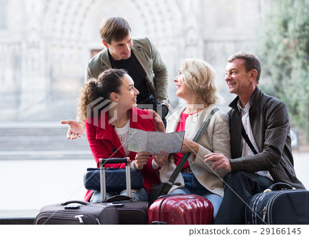 Tourists with map and baggage in city. 29166145