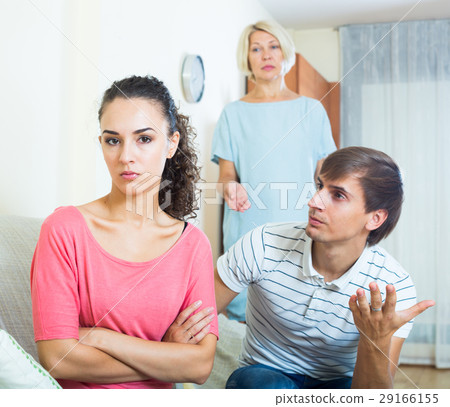 Relatives quarrelling with young woman in domestic interior Relatives quarrelling with young woman in domestic interior 29166155