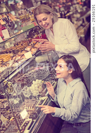 women buying dark and white chocolate filled candies 29166191