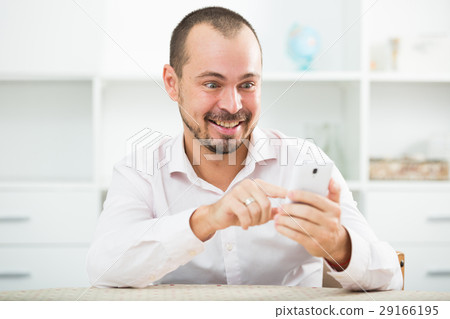 Positive young man with smartphone Positive young man with smartphone 29166195