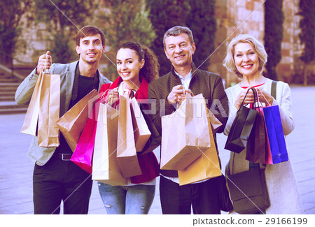 Close up of smiling tourists with purchases Close up of smiling tourists with purchases 29166199